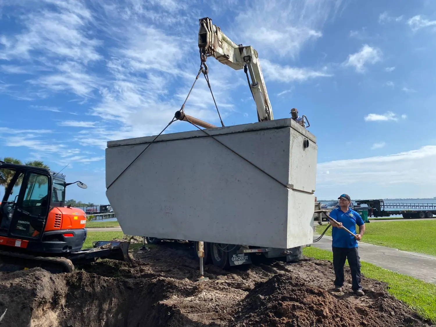 Crotty Services crew setting a septic tank with a crane